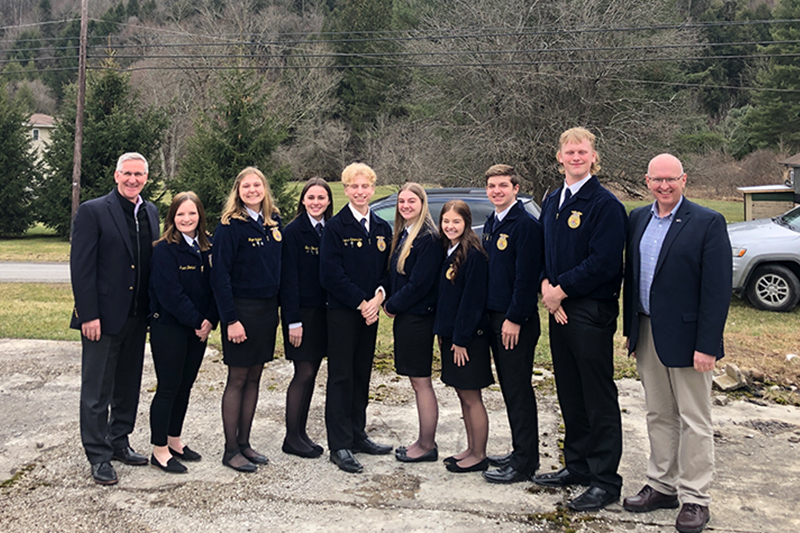 Group of AG students in suits along with two adults